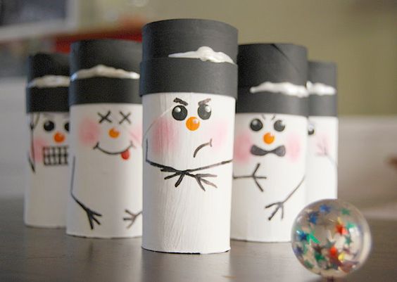 toilet paper rolls decorated like snowman and lined up like bowling pins