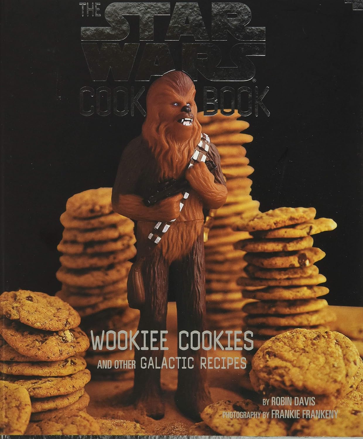 A toy Chewbacca figurine is standing amongst stacks of cookies